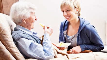 older_person_dietitian_smiling_eating_home.jpg