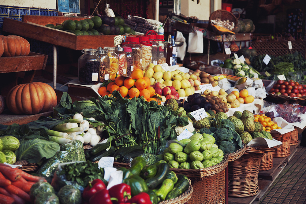 In Britain we're lucky enough to grow some fantastic fruit and vegetables. This image shows a greengrocers' fruit and veg stall with seasonal produce.